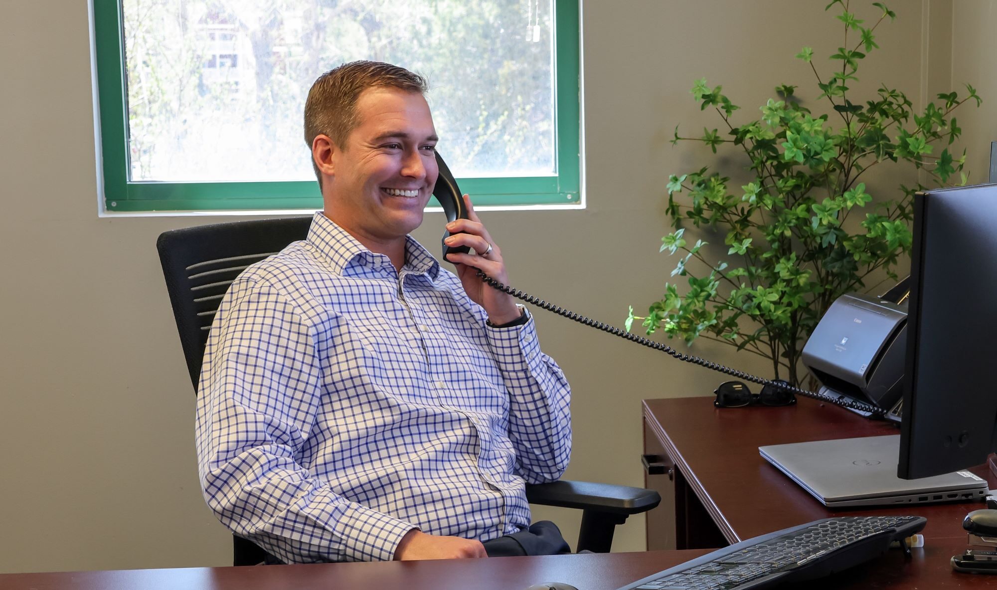 Braxton Johnson, market president, talking on the phone in his office