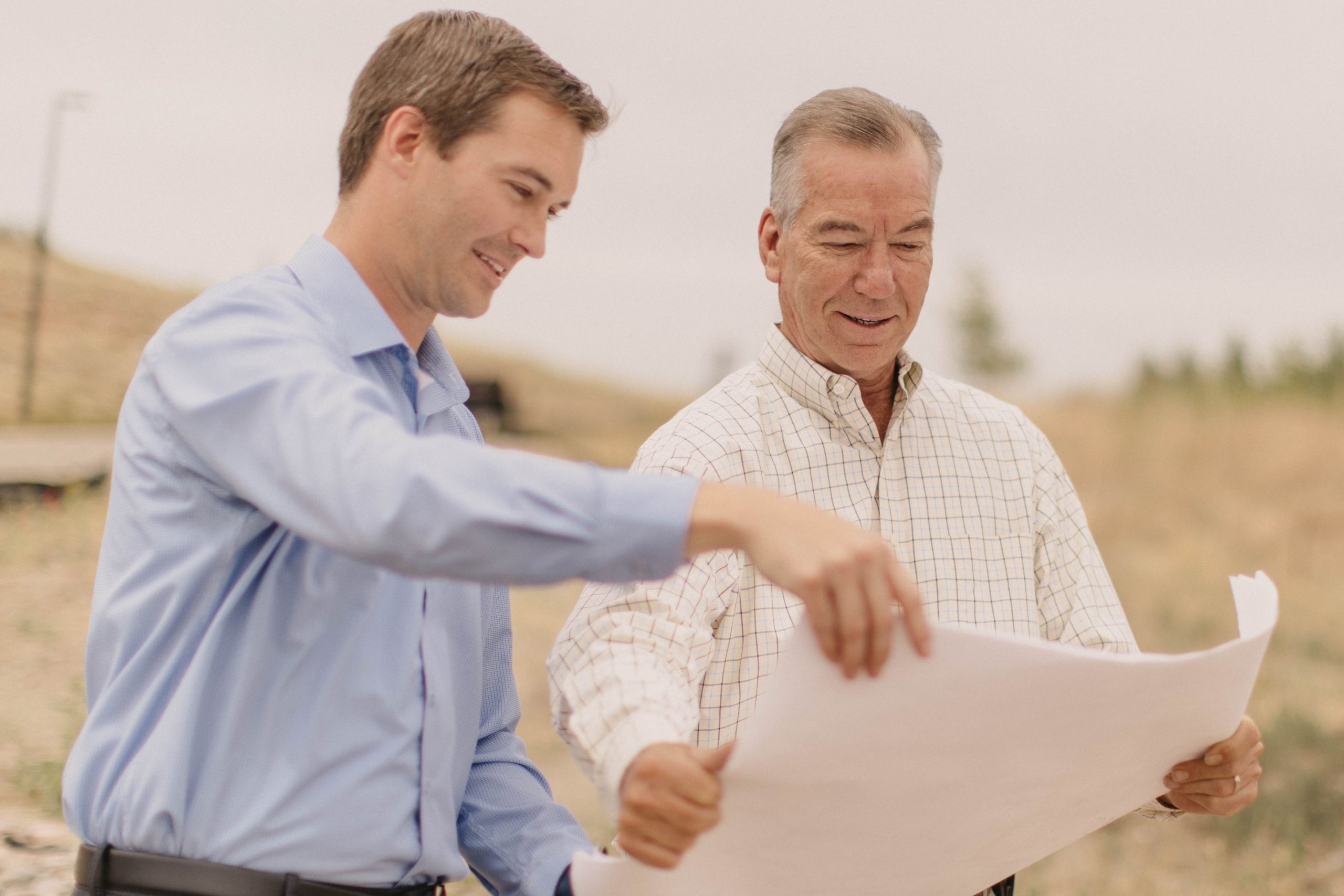 Two men examining the blueprints for a home.