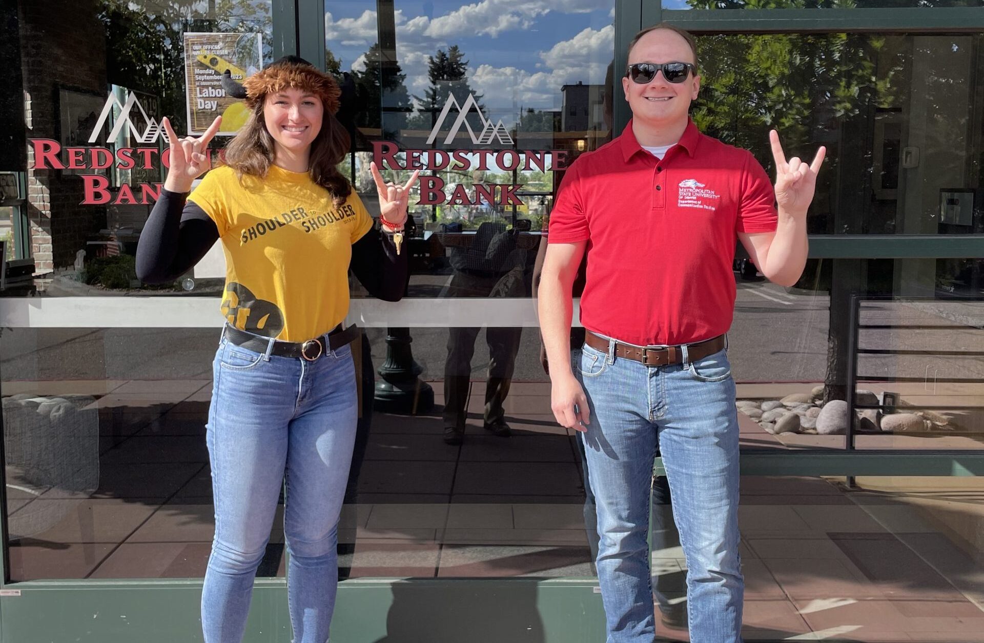 Littleton branch staff members wearing college gear in support of college football season kick off