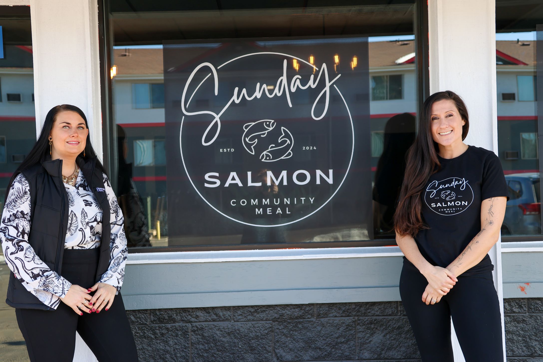 Sunday Salmon owner standing outside the business with Stephanie from Redstone Bank.