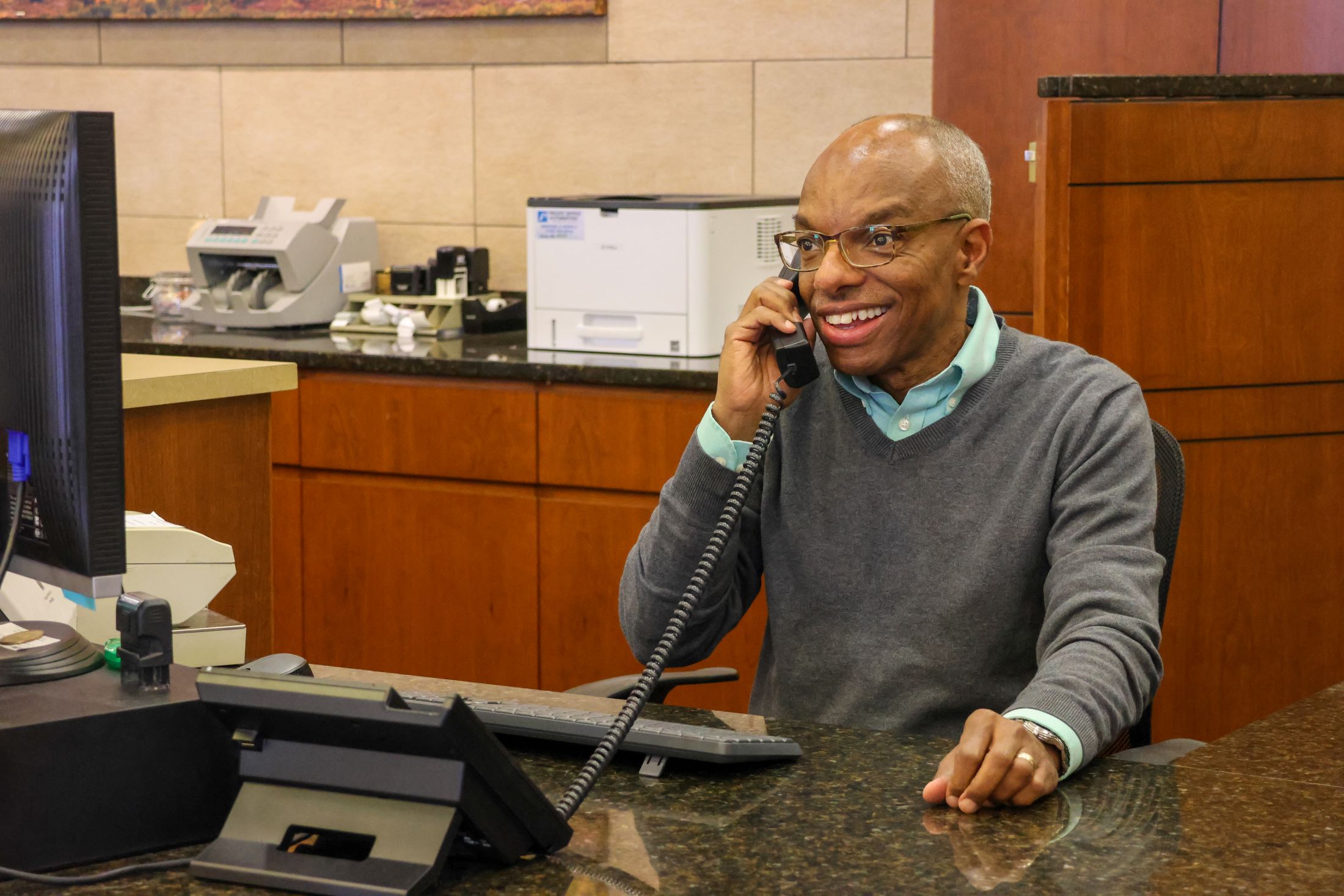 Ken Holmes, Retail Banking Manager talking on the phone at the Centennial branch