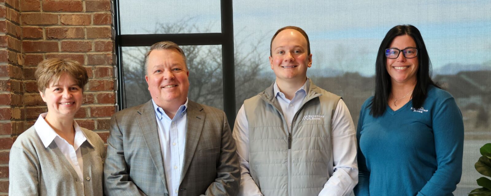 Littleton staff standing inside the branch smiling at the camera