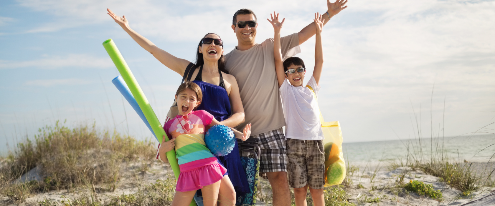 Family of four enjoying a beach vacation.